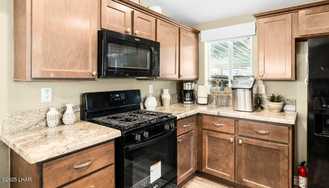 3020 Parker Dam Road, Unit 11 Parker, AZ 85344 - Photo 19 of 58 a kitchen with a stove a sink and a microwave