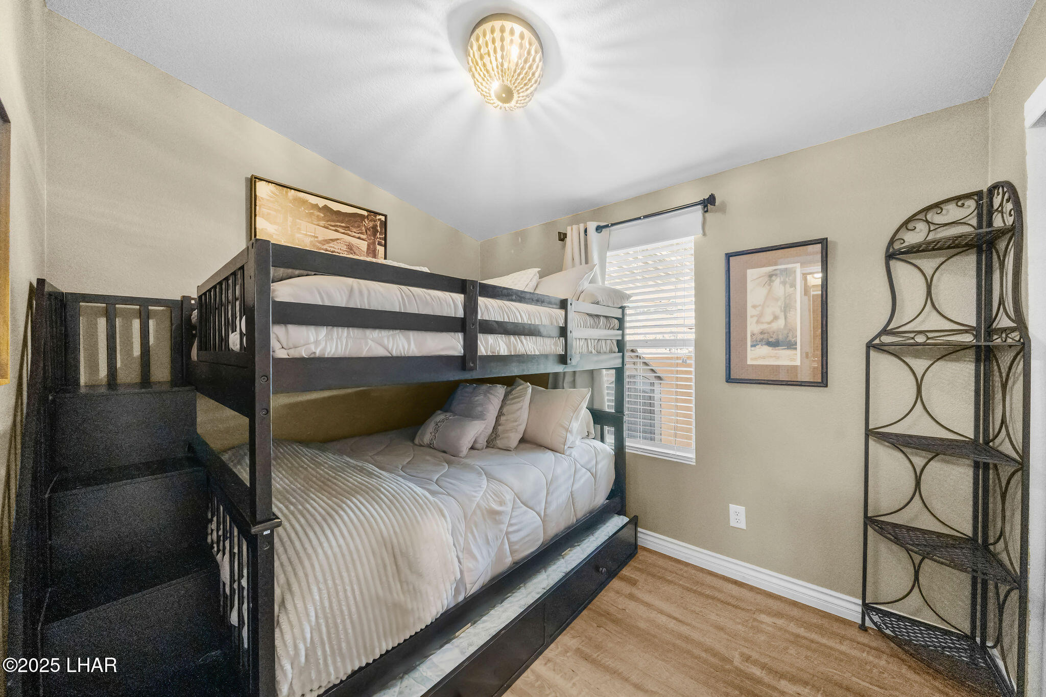 3020 Parker Dam Road, Unit 11 Parker, AZ 85344 - Photo 30 of 58 a bedroom with a bed and a chandelier