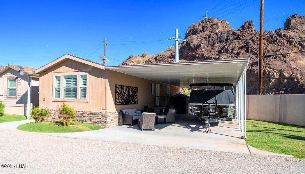 3020 Parker Dam Road, Unit 11 Parker, AZ 85344 - Photo 3 of 58 a front view of a house with a garden and sitting area
