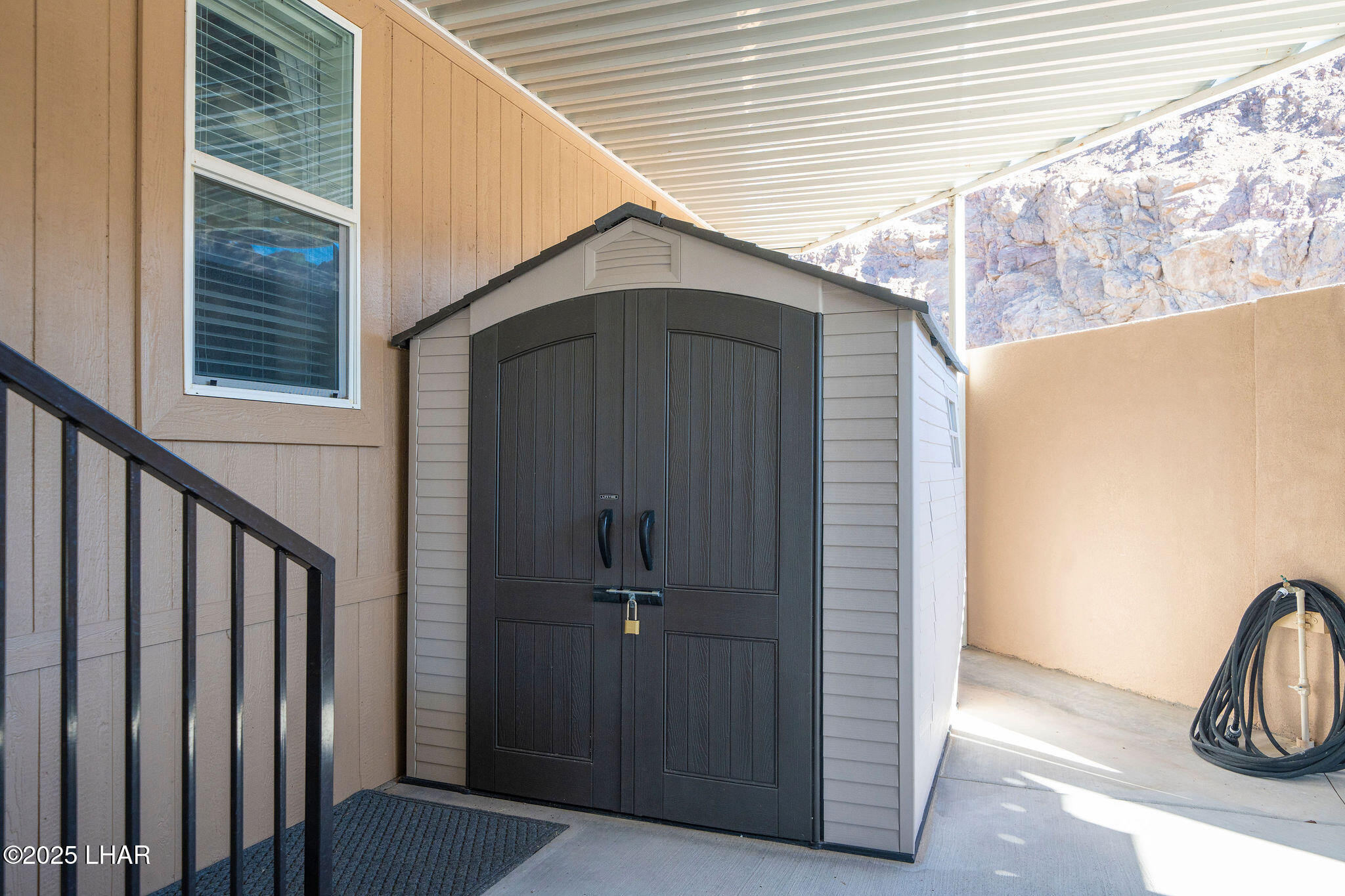 3020 Parker Dam Road, Unit 11 Parker, AZ 85344 - Photo 34 of 58 a view of a small house with wooden wall and roof