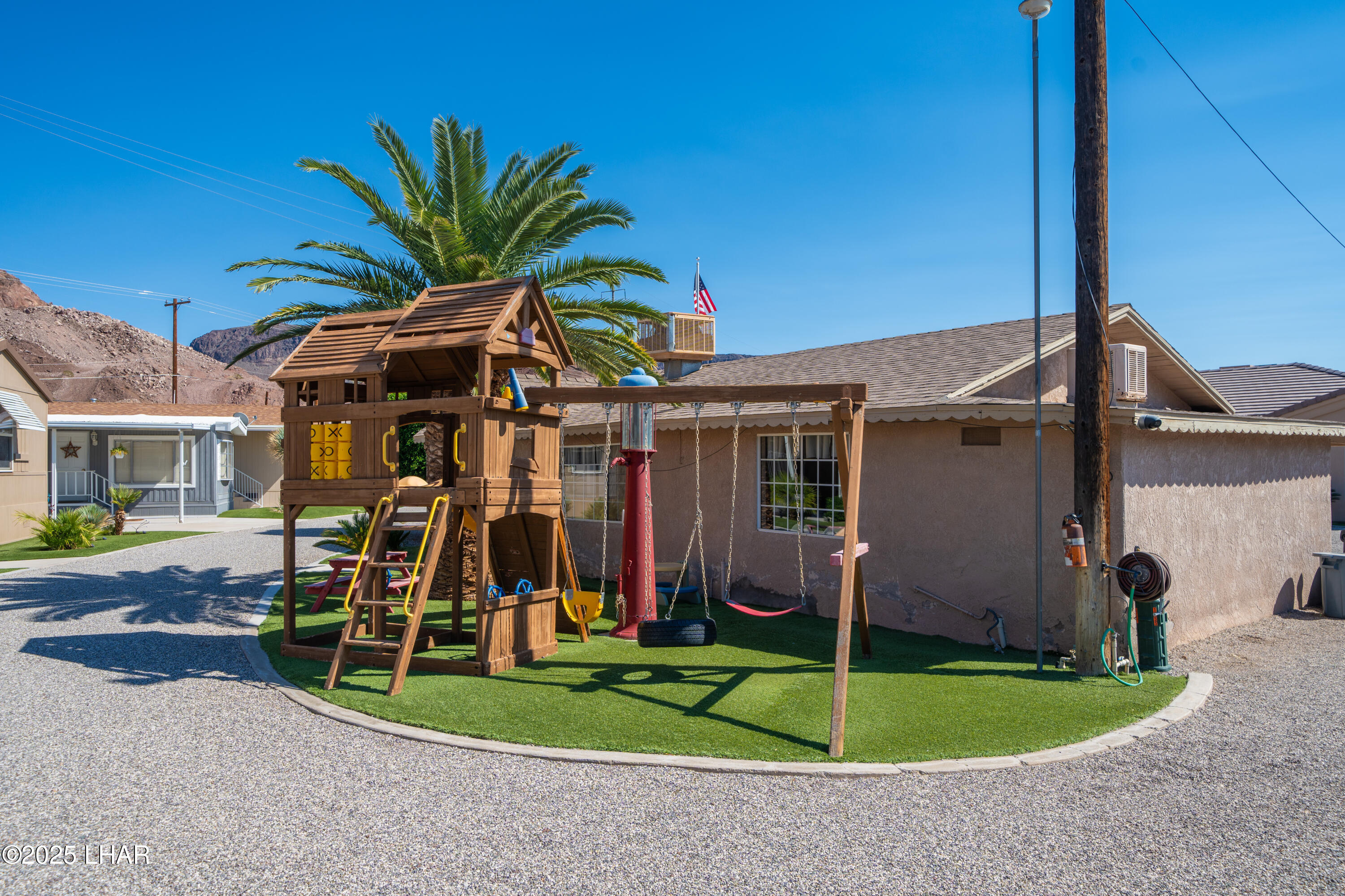 3020 Parker Dam Road, Unit 11 Parker, AZ 85344 - Photo 37 of 58 a view of a house with a patio and a yard