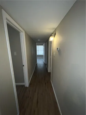a view of hallway with wooden floor