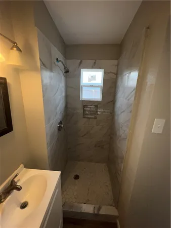 a bathroom with a shower and sink