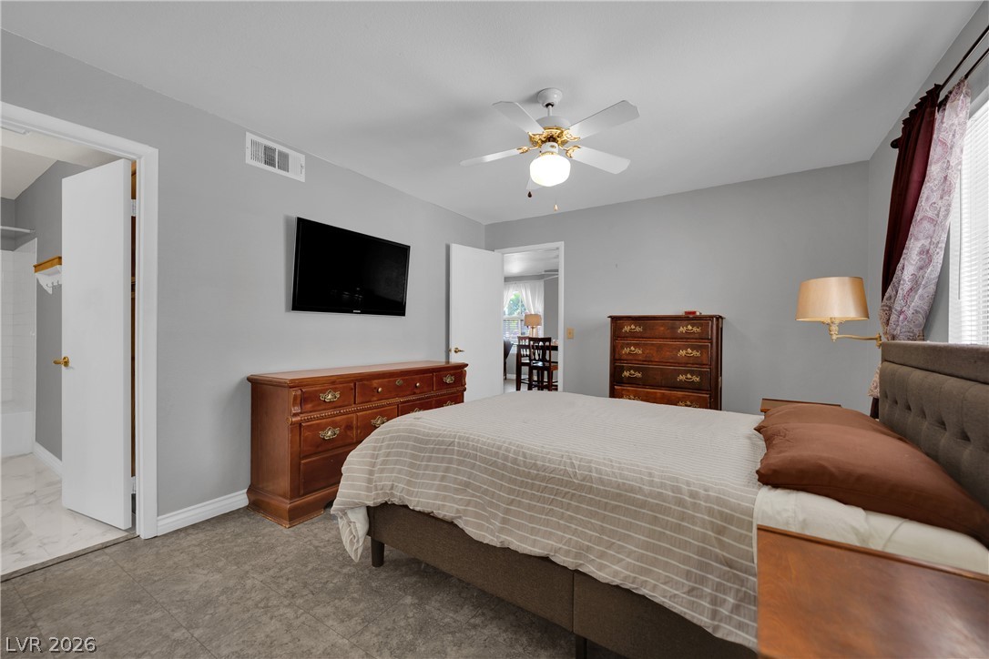 7570 West Flamingo Road, Unit 115 Las Vegas, NV 89147 - Photo 16 of 34 Discover a tranquil primary bedroom, featuring a large window, ample natural light, and a connecting private bath.