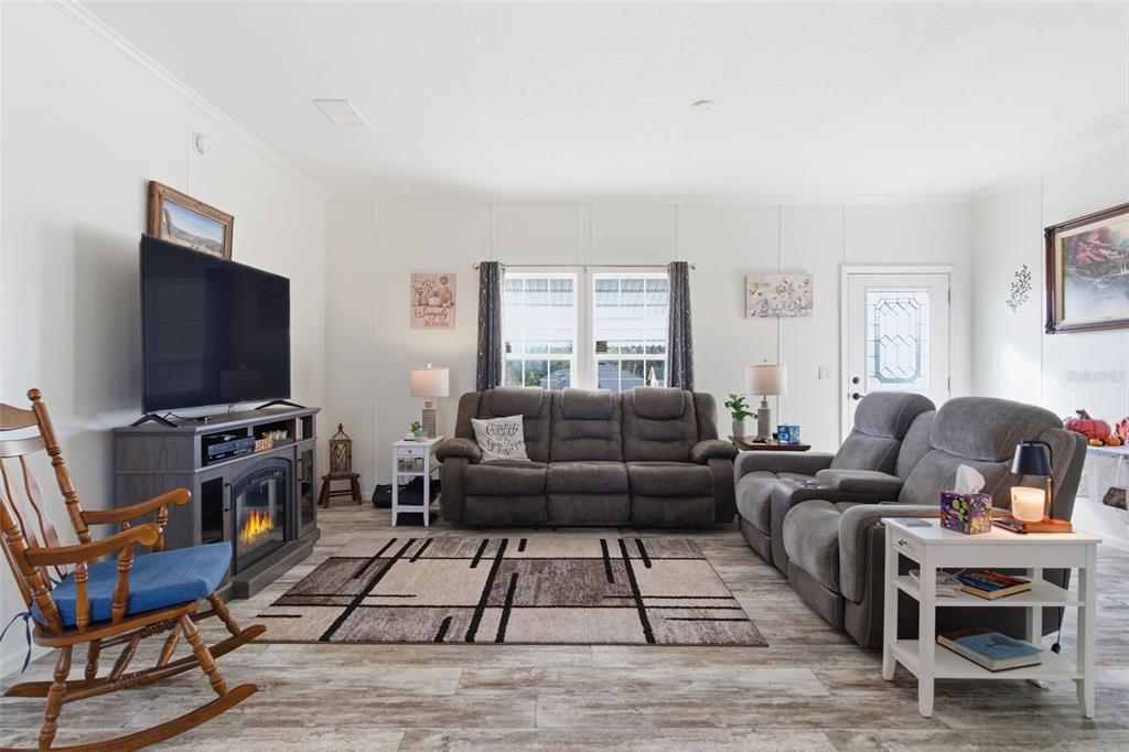 12441 Hexam Road Weeki Wachee, FL 34614 - Photo 12 of 46 a living room with furniture and a flat screen tv