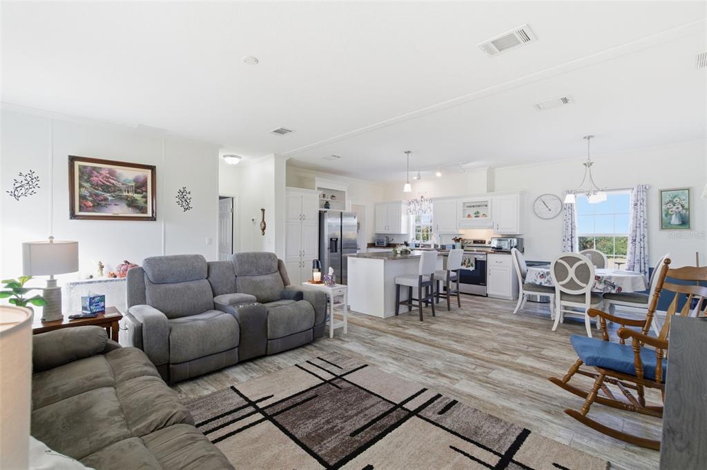 12441 Hexam Road Weeki Wachee, FL 34614 - Photo 13 of 46 a living room with furniture and a dining table with kitchen view