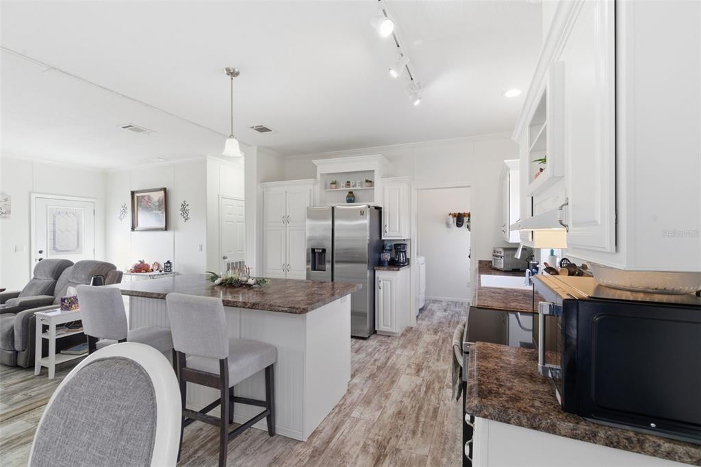 12441 Hexam Road Weeki Wachee, FL 34614 - Photo 15 of 46 a large kitchen with a table and chairs