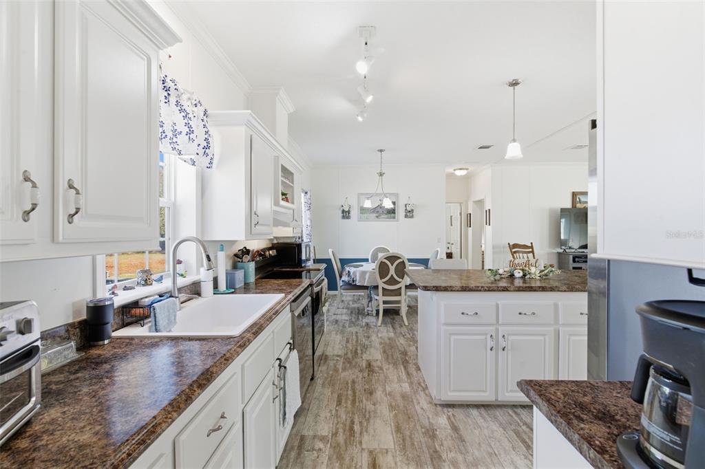 12441 Hexam Road Weeki Wachee, FL 34614 - Photo 16 of 46 a kitchen with lots of counter space and view of living room