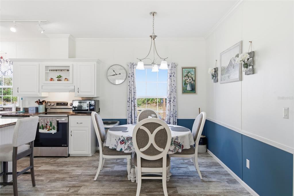 12441 Hexam Road Weeki Wachee, FL 34614 - Photo 18 of 46 a view of a dining room with furniture window and wooden floor