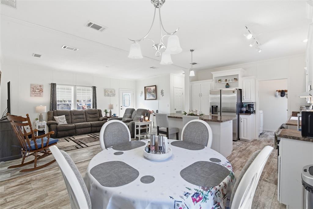 12441 Hexam Road Weeki Wachee, FL 34614 - Photo 19 of 46 a dining room with furniture a chandelier and a wooden floor