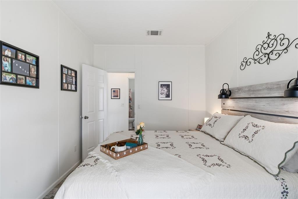 12441 Hexam Road Weeki Wachee, FL 34614 - Photo 24 of 46 a bedroom with a bed and a table in it