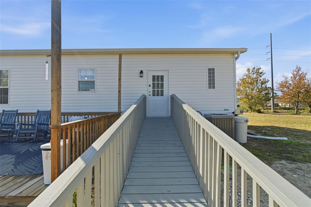 12441 Hexam Road Weeki Wachee, FL 34614 - Photo 29 of 46 a view of a balcony with wooden floor and fence
