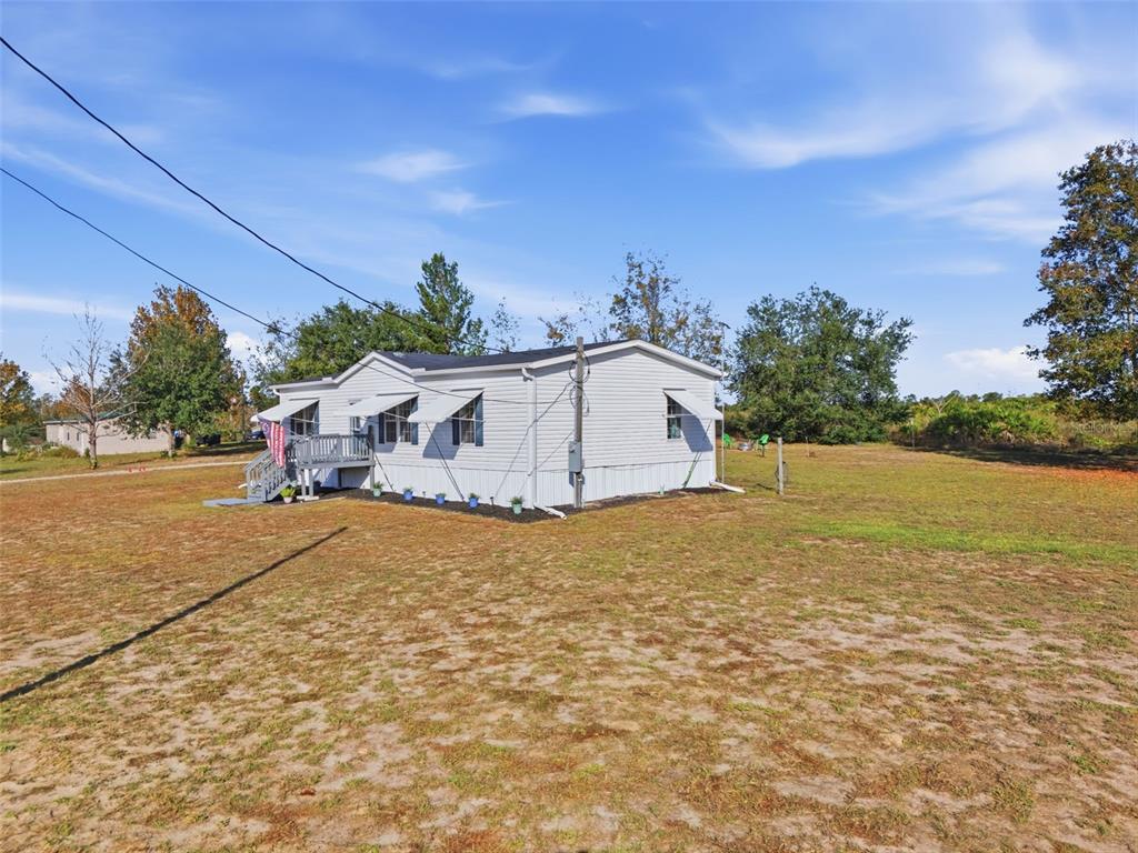 12441 Hexam Road Weeki Wachee, FL 34614 - Photo 4 of 46 a yellow and white house with a yard
