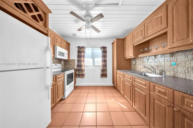 a large kitchen with stainless steel appliances a counter space a sink and cabinets