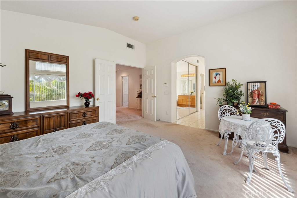 414 Helix Way Oceanside, CA 92057 - Photo 23 of 49 a spacious bedroom with a bed and a large mirror with window