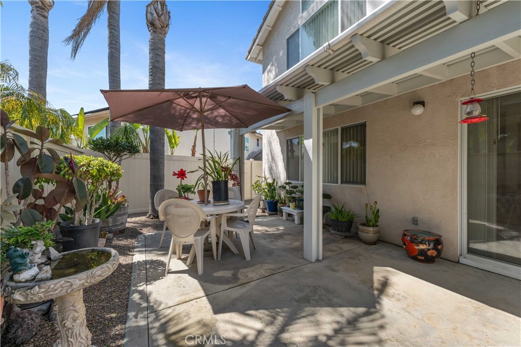 414 Helix Way Oceanside, CA 92057 - Photo 34 of 49 a view of a patio with table and chairs under an umbrella