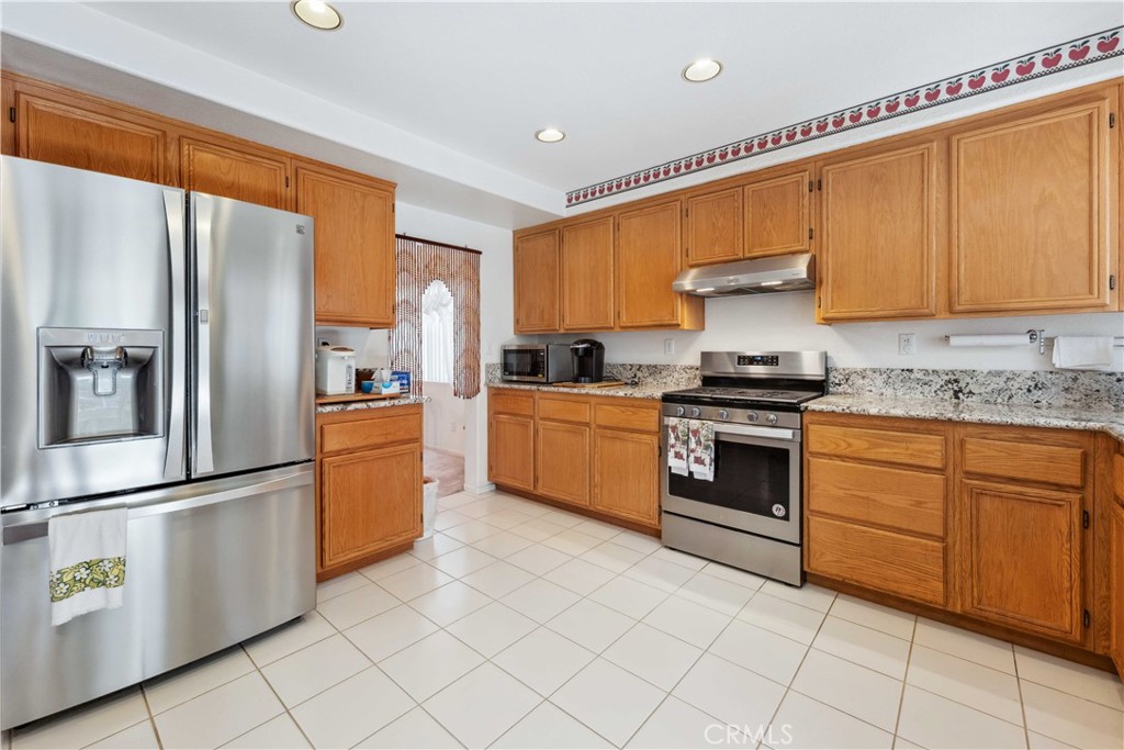 414 Helix Way Oceanside, CA 92057 - Photo 4 of 49 a kitchen with granite countertop a sink stainless steel appliances and cabinets