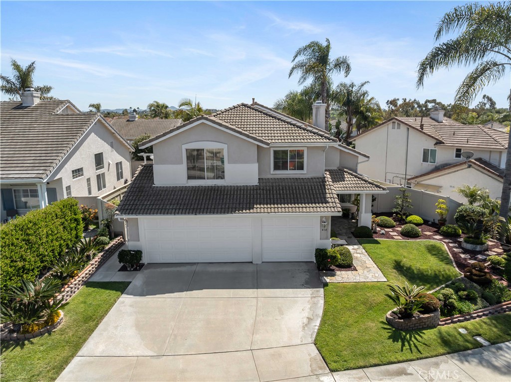 414 Helix Way Oceanside, CA 92057 - Photo 44 of 49 a front view of a house with a yard and potted plants