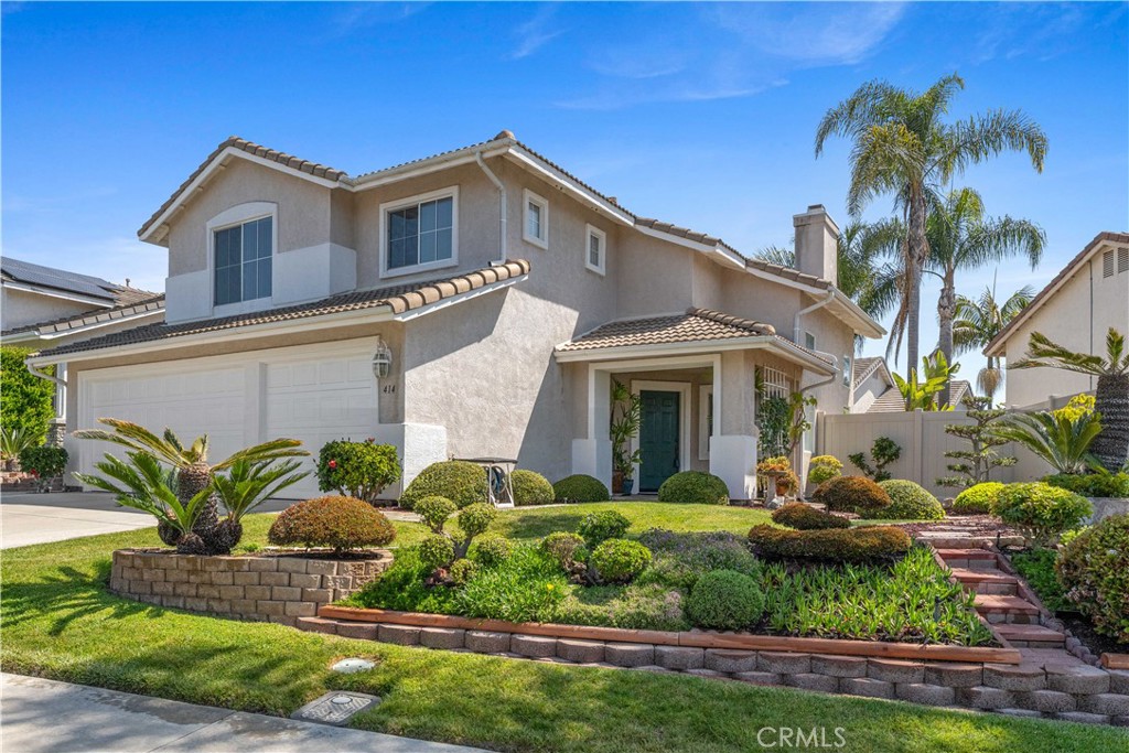 414 Helix Way Oceanside, CA 92057 - Photo 46 of 49 a front view of a house with a yard and potted plants