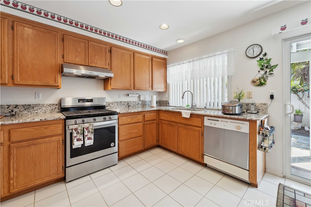 414 Helix Way Oceanside, CA 92057 - Photo 5 of 49 a kitchen with stainless steel appliances granite countertop a stove sink and cabinets