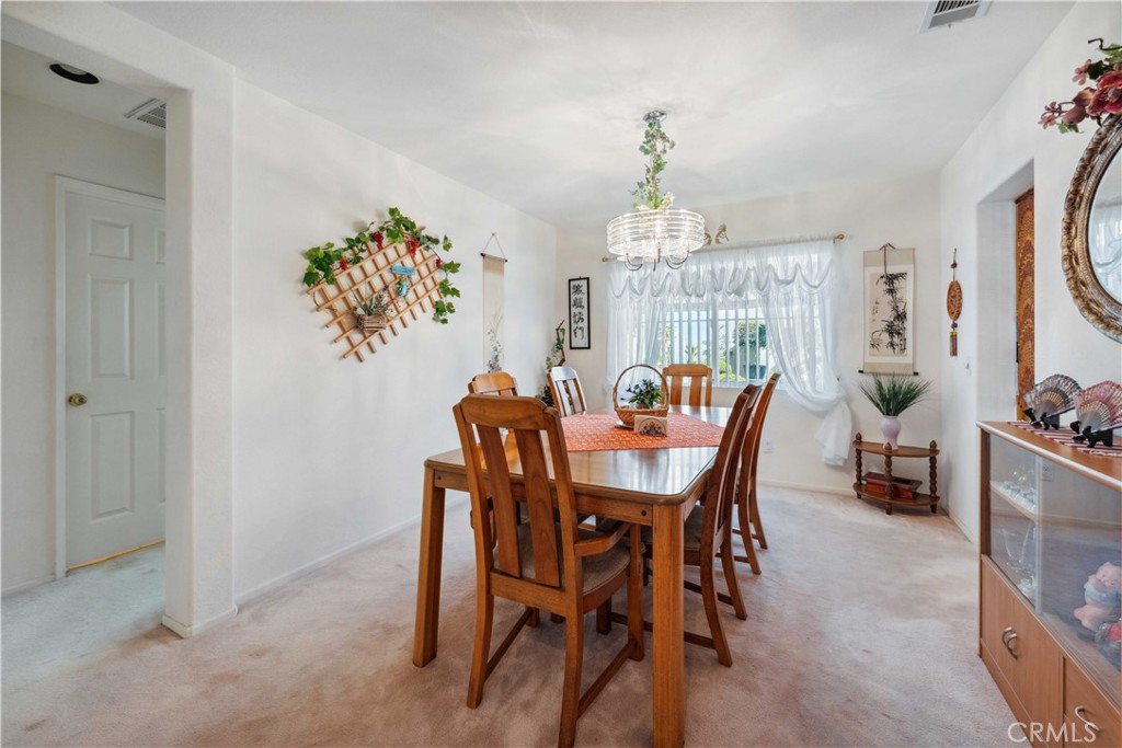 414 Helix Way Oceanside, CA 92057 - Photo 10 of 49 a view of a dining room with furniture and chandelier