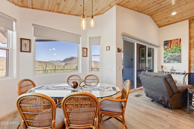a dining room with furniture and wooden floor