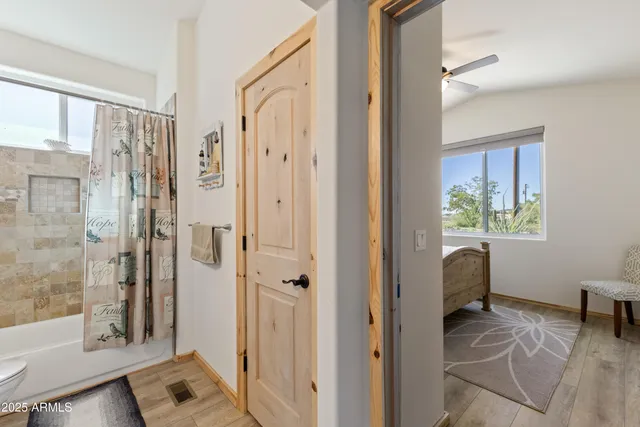 a view of a bathroom with a tub and shower