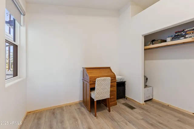 a room with a chair and a window