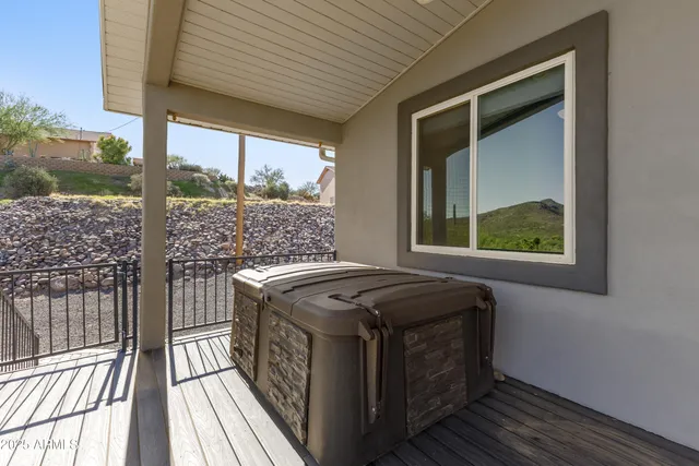a utility room with stainless steel appliances granite countertop a stove a sink and a large window