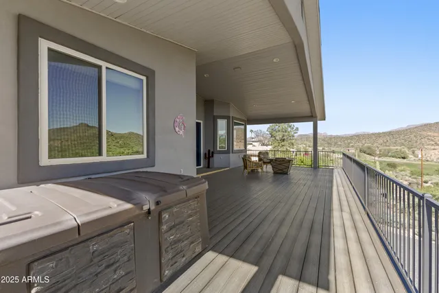 a view of a balcony with chair and wooden floor