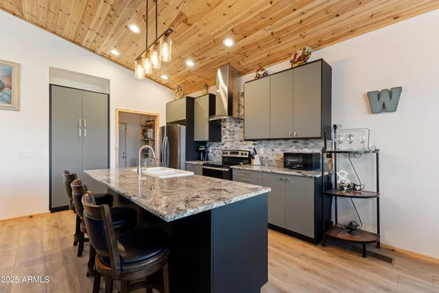 a kitchen with a table chairs refrigerator and cabinets