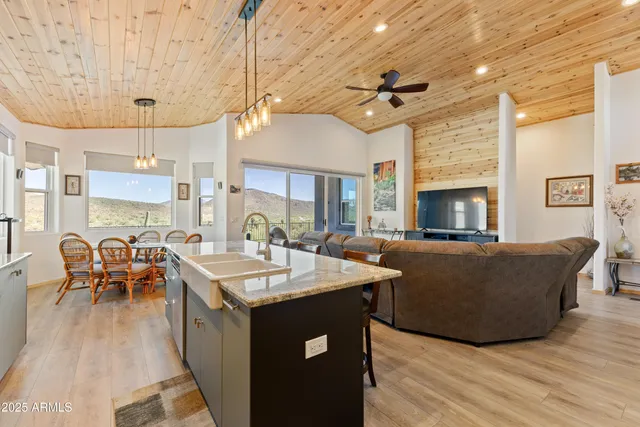 a living room with furniture a table and chairs