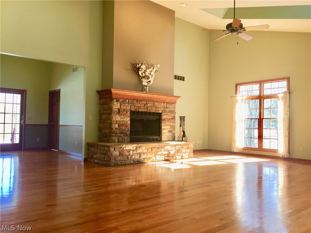 18925 Thorpe Road Chagrin Falls, OH 44023 - Photo 12 of 34 The heart of the home is this stunning family room with vaulted ceiling, recessed lights, sun lights, fan, stone fireplace, hardwood floors and plenty of windows for natural light. Room is open to the dinette/sitting room, slider to back porch and kitchen to the left. Amazing room!