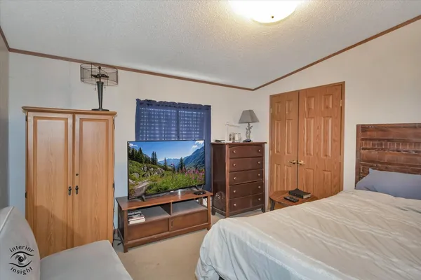 a bedroom with a bed and a chair