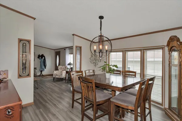 a view of a dining room with furniture wooden floor and chandelier