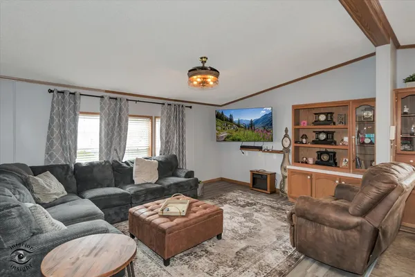 a living room with furniture a rug and a window