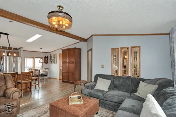 a living room with furniture and a chandelier