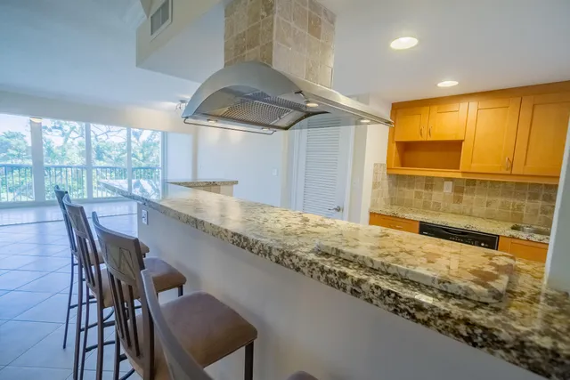 a kitchen with granite countertop window and wooden floor