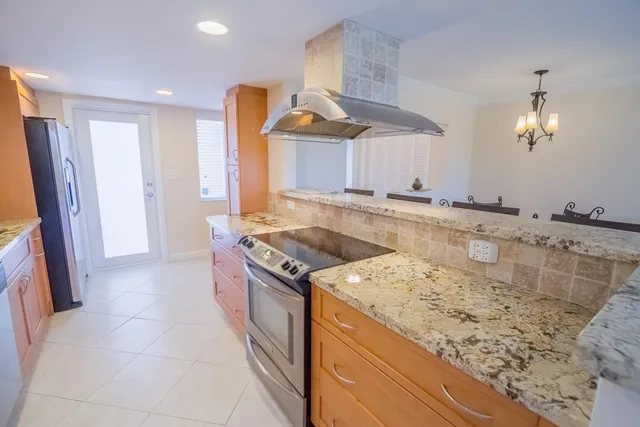 a kitchen with a sink stove and refrigerator