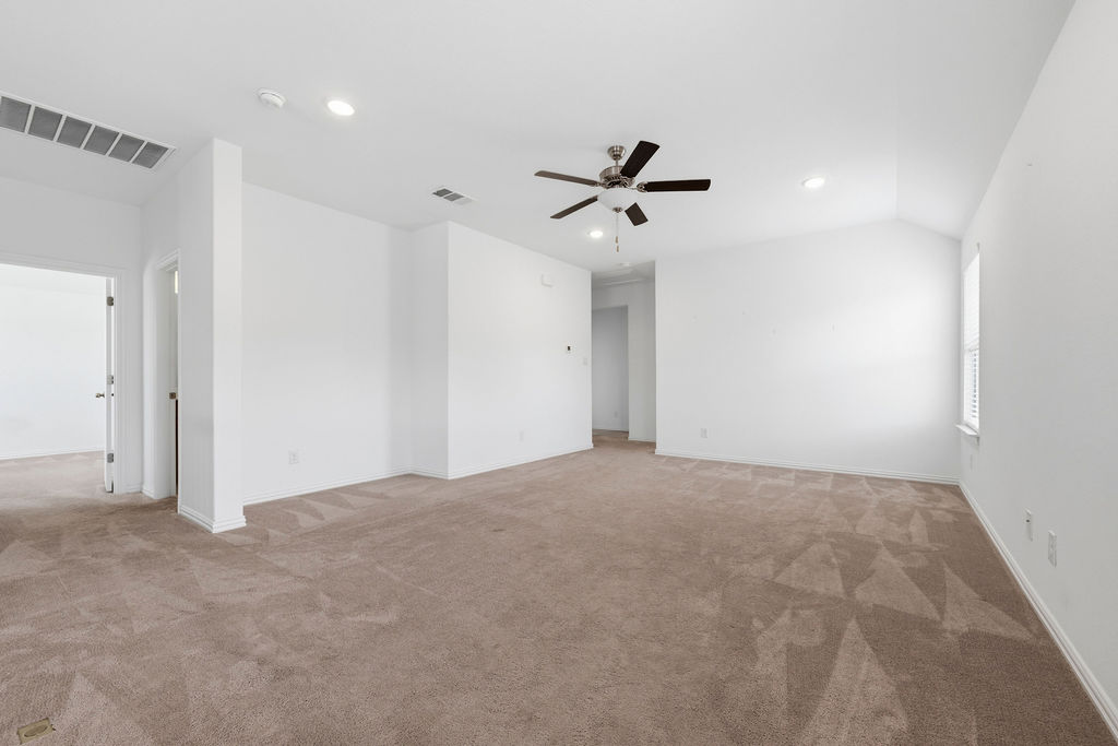 1005 Ridge Runner Drive Georgetown, TX 78628 - Photo 16 of 32 Spacious room featuring vaulted ceilings, recessed lighting, a ceiling fan with integrated light, warm-toned carpeting, and white window blinds