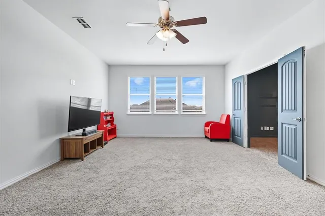 an empty room with furniture and a flat screen tv