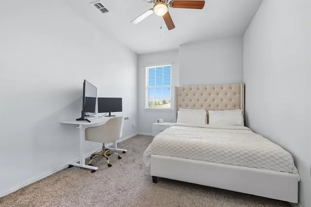 a bedroom with a bed and a desk