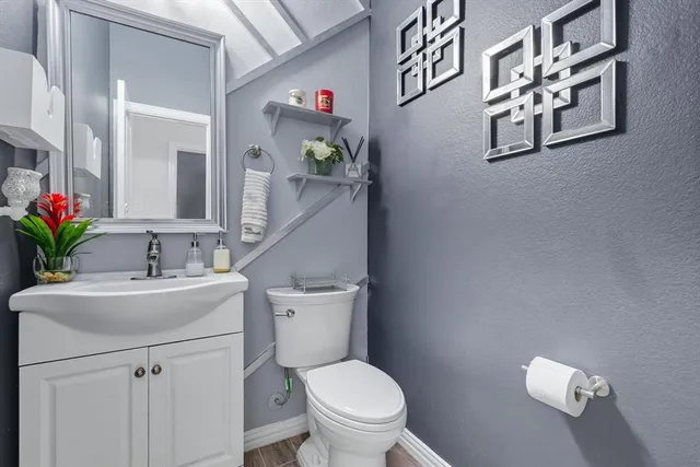 a bathroom with a toilet sink and mirror