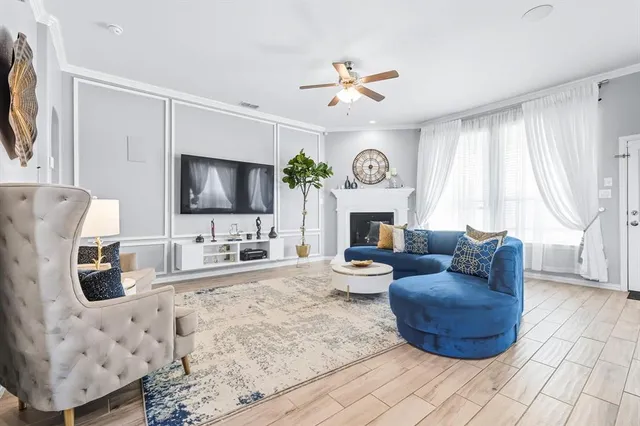 a living room with furniture a fireplace and a flat screen tv