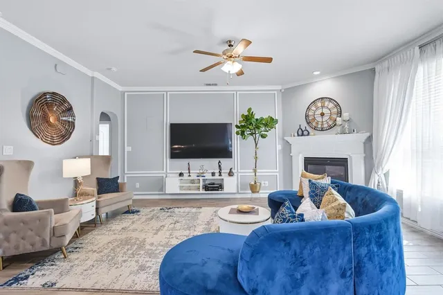 a living room with furniture a chandelier and a fireplace
