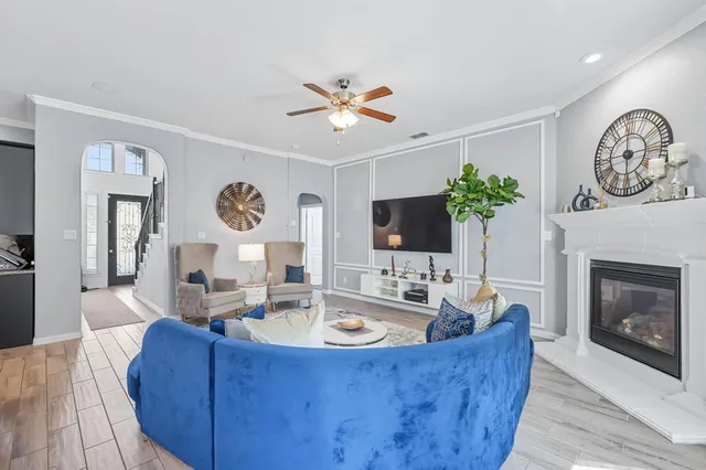 a living room with furniture a fireplace and a flat screen tv