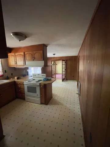 a kitchen with stainless steel appliances a refrigerator a sink a stove a microwave and island