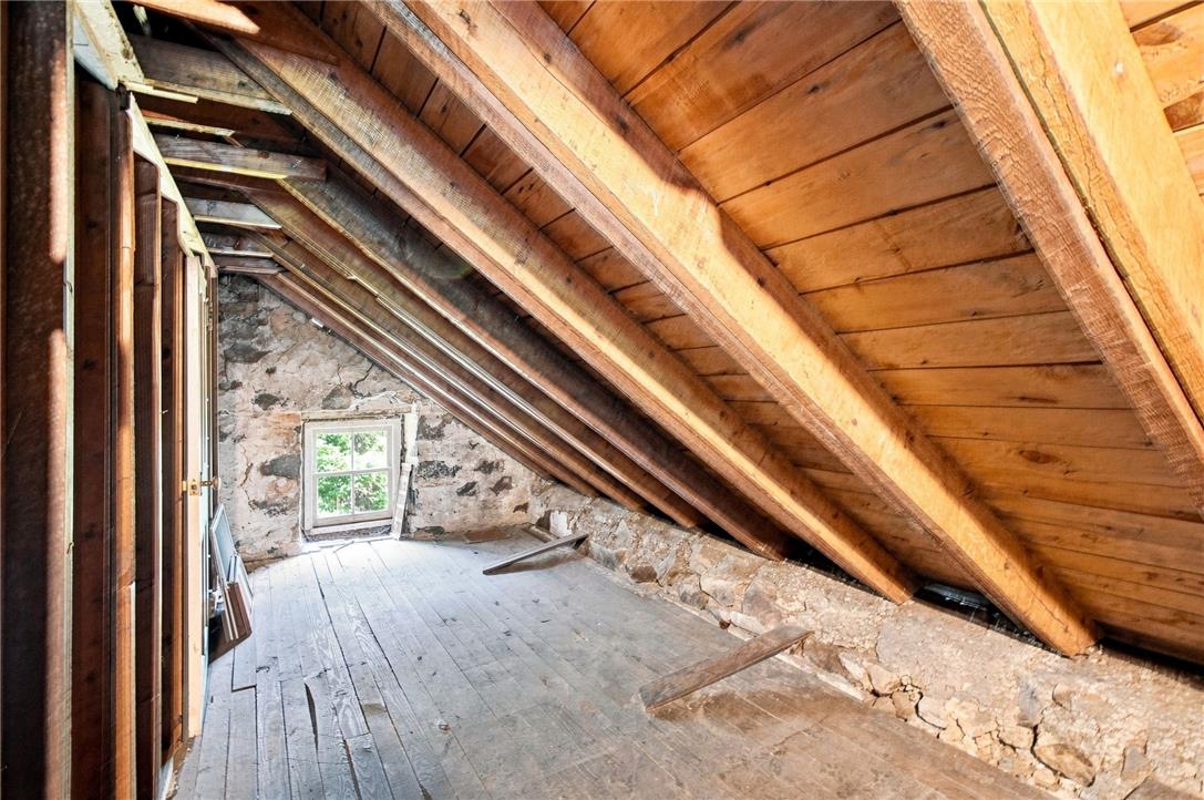 3408 Oak Hill Road Emmaus, PA 18049 - Photo 58 of 93 Exposed wood framing and historic stone walls define this rustic attic space.