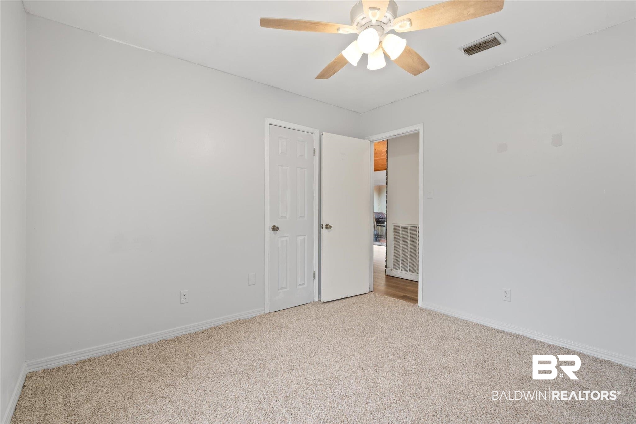 9445 Howells Ferry Road Semmes, AL 36575 - Photo 18 of 20 Unfurnished room featuring ceiling fan and light colored carpet