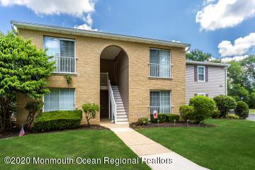 503 Harding Road, Unit 6 Freehold, NJ 07728 - Photo 2 of 23 a front view of a house with a yard and trees